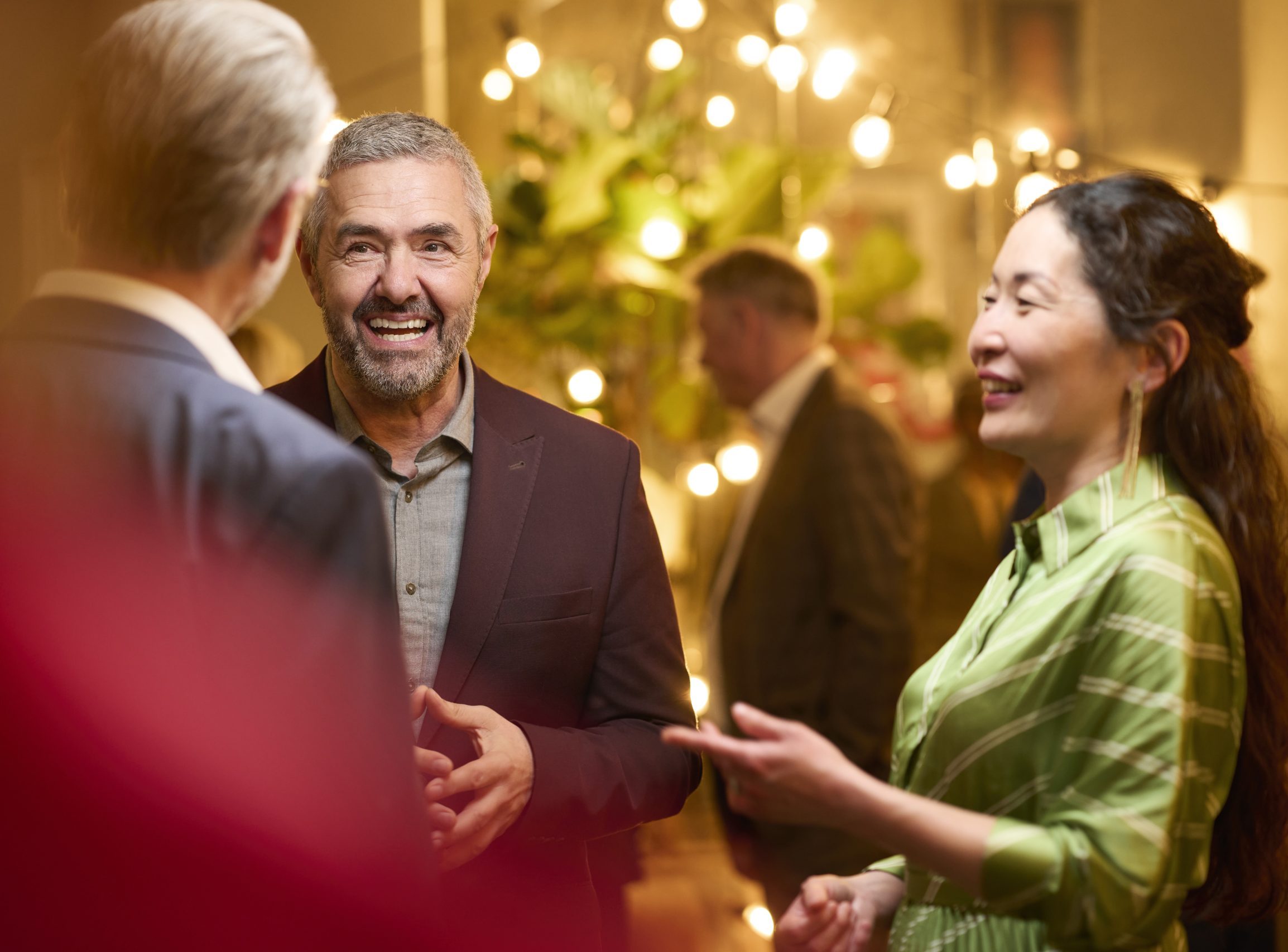 A gathering of friends, laughing and smiling. One with a ReSound hearing aid for clearer moments.